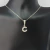 Colar de prata 925 com letra C cravejada de zircônias.