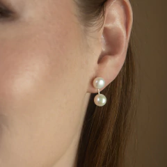 Brinco feminino Gemini M com duas pérolas brancas, uma fixa na orelha e outra pendurada em um fio fino