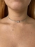 Colar Nobre prateado com detalhes em zircônia, ajustado ao pescoço.