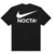 Camiseta preta da colaboração Nike x Nocta com logotipo Nike e a palavra "NOCTA" em destaque nas costas.