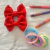 Set 2 moños escolares Rojas + 6 colitas pasteles - comprar online