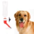 Bebedero plástico transparente con boquilla roja para canil o jaula junto a un perro golden retriever con la lengua afuera