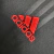 Logo da Adidas em vermelho bordado sobre fundo preto da camisa Flamengo III 19/20.
