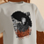 Camiseta Lady Gaga MAYHEM Dance or Die Oversized Off White / Laranja na internet