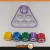 Conjunto do jogo Gonggi inspirado em Round 6, com peças coloridas em formato de figuras geométricas e um tabuleiro triangular.