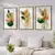 Três quadros decorativos com ilustrações de flores verdes e laranjas em molduras de madeira.