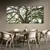 Trio de quadros decorativos com imagens de uma árvore, emoldurados, dispostos na parede acima de uma mesa de jantar com cadeiras modernas.