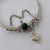 Pulsera Dora con Dijes - con bolsita premium - Corazon Inflada Negro PAR270 - comprar online