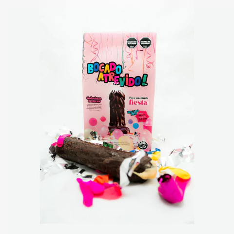 Bocado atrevido pene comestible bañado en chocolate de 16 cm con caja rosa y globos de colores para fiesta