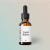 Frasco âmbar com conta-gotas contendo Cogni Bitters, suplemento para saúde da mulher e bem-estar intestinal