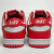 Tênis Nike Dunk Low feminino na cor vermelha e branca, feito de material sintético, com vista traseira destacando os detalhes do design.