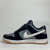 Tênis feminino Nike Dunk Low, cinza e preto, com detalhes em branco, visto de perfil.