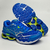 Tênis Mizuno Wave Creation 20 na cor marinho e royal, com detalhes em verde, exibindo a parte frontal e a sola do calçado.