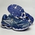 Tênis Mizuno Wave Creation 20 na cor branca e marinho, exibindo detalhes de design e sola.