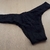 Calcinha tanga rendada na cor preta, ideal para tamanhos grandes, com detalhes em renda.