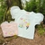 Blusinha feminina infantil branca com mangas de tule e estampa colorida de flores, corações e sol.