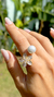 Anel - pérola shell branca com zircônia em flor no banho de ouro 18k