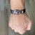 Image of PULSEIRA COURO PRETA CRUZ FINA BANHADO RÓDIO NEGRO - (cópia)