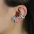 Aros de plata entrelazados con circonias y detalle en verde esmeralda - comprar online
