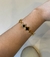 Pulseira trevo preto e dourado vazado