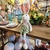 COELHO/A DE PÁSCOA PELÚCIA SENTADO ROUPA FLORAL 53CM - Itália Decor