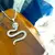 Dije Serpiente con cristales en acero en internet