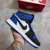 FN - Bota Air Jordan 1 Mid Azul, Branco e Preto