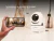 Cámara de seguridad Gadnic SX9 blanca con movimiento motorizado de 360 grados horizontal y 120 grados vertical, mostrando control desde un celular