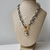 Colar Folheado a Ouro 18k correntaria fecho gravata com pingente de cadeado - comprar online