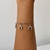 Pulseira aço inox com pingente de ferraduras - comprar online