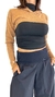 Sweater Emilia tostado combinado con prenda negra ajustada.