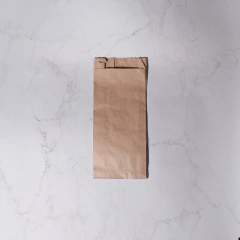 Bolsa con fuelle de papel kraft en posición vertical sobre un fondo claro.