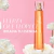 Perfume FIORI de Ésika para mujer rodeado de rosas blancas y fondo rosado, texto "Fuerza que florece, irradia tu esencia" 