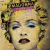 Capa do CD Madonna Celebration com imagem estilizada de Madonna em fundo amarelo com efeitos de jornal e maquiagem azul nos olhos