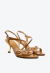 Sandália em couro marrom Cecconello com salto vírgula dourado, tiras assimétricas e esferas metálicas. Elegância máxima para looks sofisticados. Aproveite!