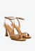 Sandália em couro marrom com salto alto taça, tiras cruzadas e esferas douradas. Conforto e elegância para looks sofisticados. Garanta já a sua!