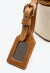 Bolsa baú box Cecconello em couro marrom e linho cru, com alça removível, espelho integrado e design utilitário-chique. Garanta já a sua elegância!