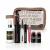Set de maquillaje completo Regina con neceser transparente y productos variados como spray fijador, máscara de pestañas, delineador, aceite labial y dos blush stick mini.