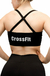 Vista trasera de un top deportivo negro con tiras cruzadas y la palabra "CrossFit" impresa en blanco