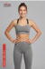 Modelo femenina sonriente con conjunto deportivo gris Conjunto Perla Largo de Miro Sports, compuesto por top y legging ajustado