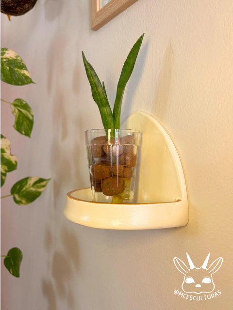 Altar de parede ritualístico, com vaso de vidro contendo planta e pedras decorativas