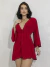 Mulher usando vestido vermelho manga flare com decote em V