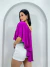 Mulher vestindo blusa bata assimétrica fúcsia com um ombro à mostra