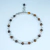 Pulsera tejida con ojo de tigre - Veinte Dedos