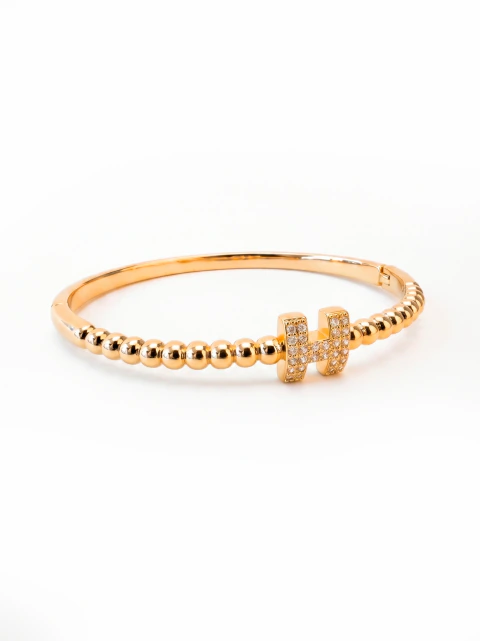 BRACELETE ESFERAS "H" CRAVEJADO DOURADO