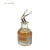 Frasco de perfume feminino Brand Collection Nº 136 com tampa prateada em formato de pernas femininas para o ar e líquido âmbar