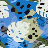 Fibrana Estampada de hojas en tonos azules y verdes sobre fondo colorido, ideal para telas de indumentaria.