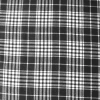 Tela de lana con diseño de cuadros en blanco y negro, ideal para confección de prendas de abrigo.