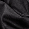 Textura de gamuza negra, suave y aterciopelada, con pliegues visibles.