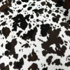 Tela gabardina con estampado animal print tipo vaca en colores blanco, negro y marrón
